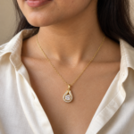 Gold teardrop pendant necklace with clear stone center