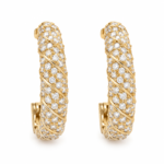 Pair of gold pavé twist hoop earrings on white background