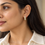 Woman wearing elegant pavé gold hoop earrings