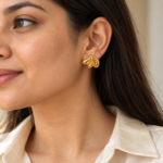 Woman wearing Shell-Kissed Gold Plated Studs on her ear