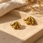 Pair of shell-inspired Gold Plated Studs on white background