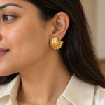 Woman wearing Shell Radiance Gold Plated Studs on her ear