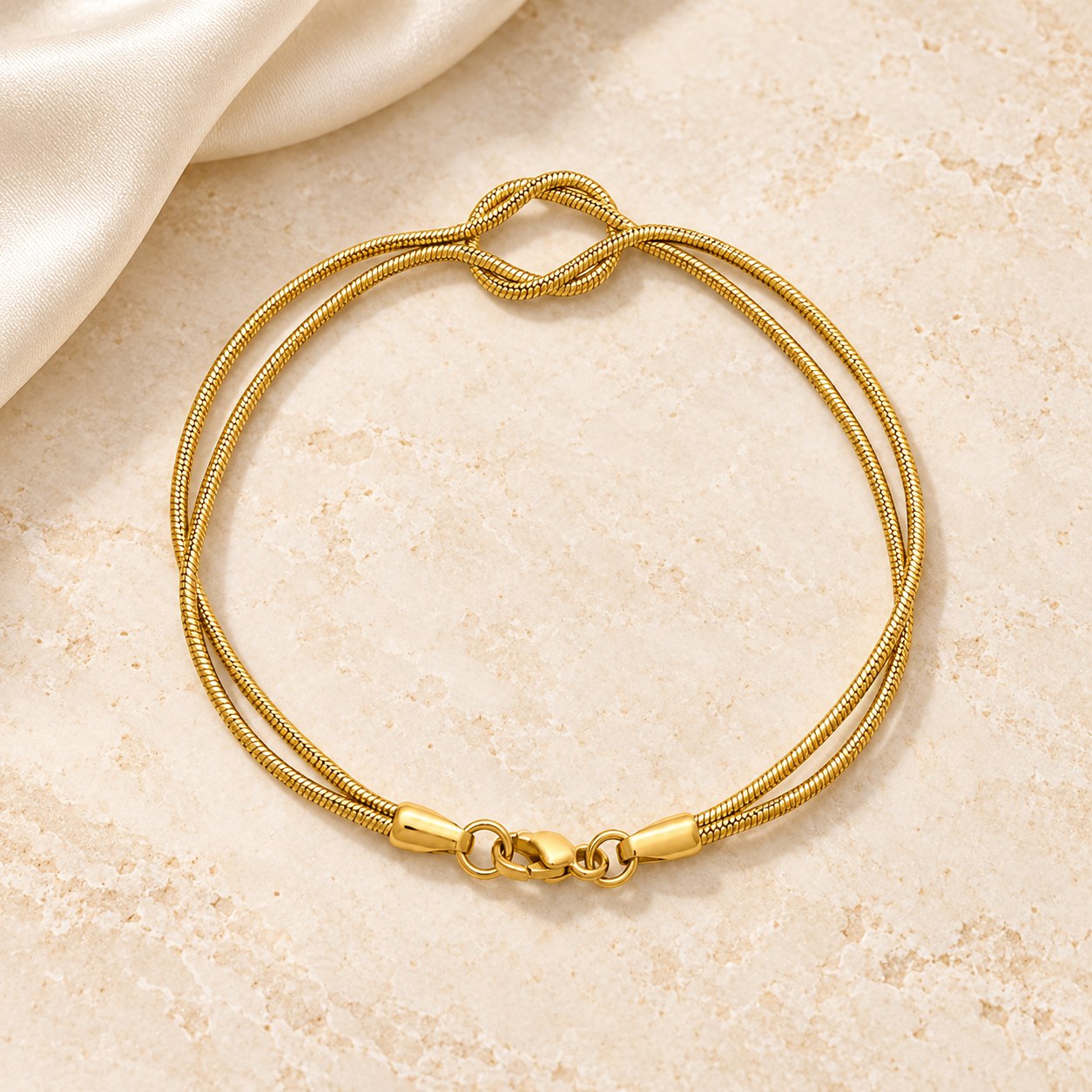 Gold plated double-strand knot bracelet on ivory stone and silk