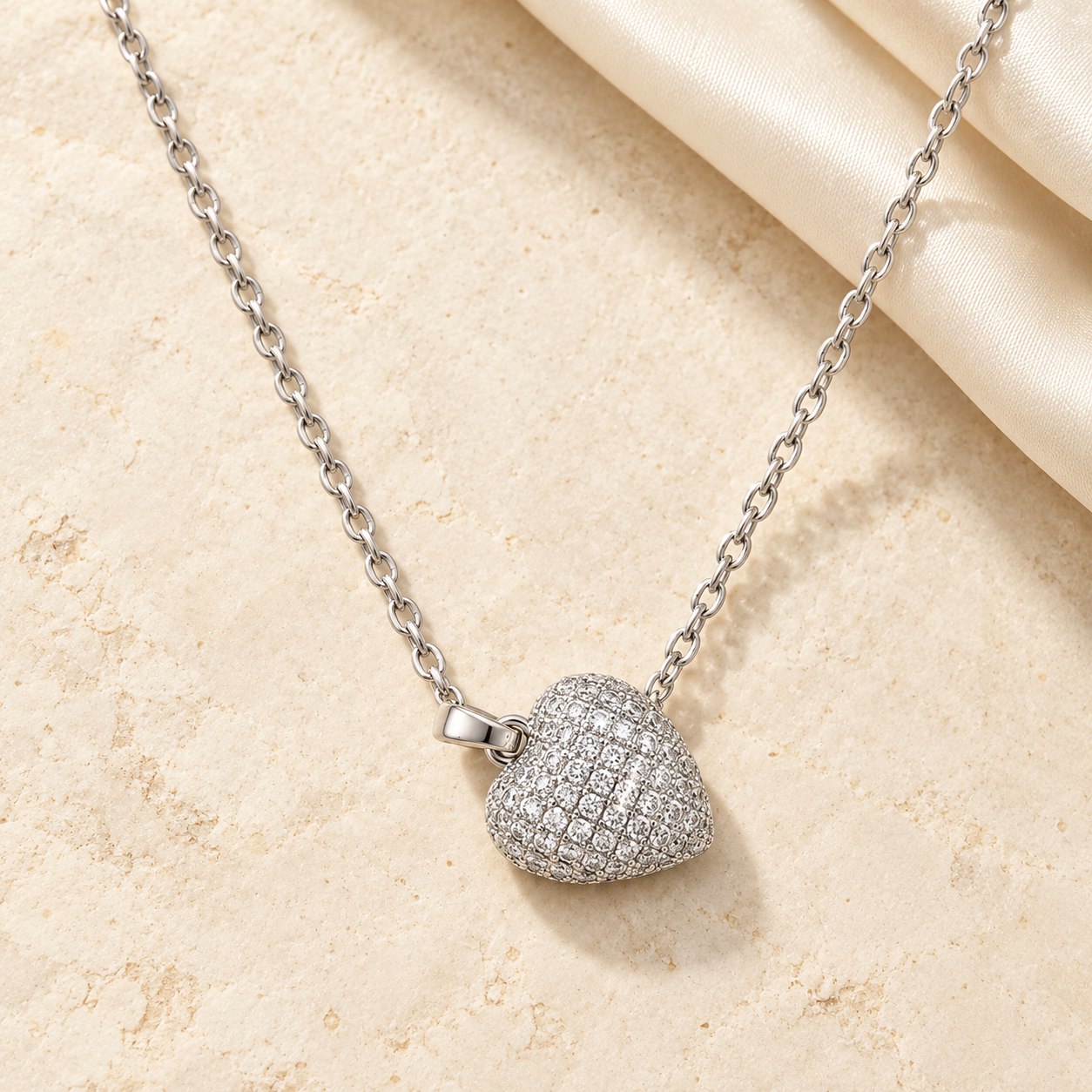 Silver-tone crystal heart pendant necklace on ivory stone and silk