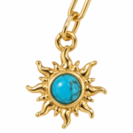 Detailed view of the turquoise sun charm on the gold chain