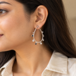 Model wearing minimalist drop crystal hoop earrings