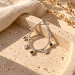 Elegant pair of silver tone drop-style crystal hoop earrings